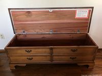 Open cedar chest showing interior cedar lining, lock mechanism, and stamped Lane branding on inside lid.