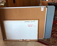 Photo of wood framed whiteboard 36x24 inches in front of 2 cork boards.