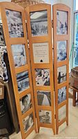 Full view of the 3-panel wooden room divider featuring displayed black-and-white photos in rectangular slots