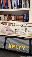 Photo of the original packaging showing Kelty Switchback tent details and a gray Kelty-branded carrying bag.