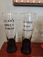 Two beer glasses with humorous text 'I CAN'T ADULT TODAY' and 'I Make Pour Decisions'