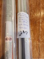 Two Whole Home PVC roller blinds in original packaging, labeled with size 37.25 x 70 inches, Amelia style, plain hem, dark chocolate/light stone grey color.