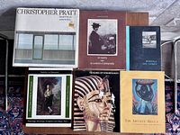 Seven assorted vintage art books laid out on a surface, showing front covers and titles.