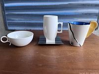Full view of the three coffee cups positioned side by side showing their shapes and relative sizes.