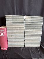 Stacked volumes of The Yale Shakespeare collection showing faded blue spines with gold lettering and one red hardcover volume.