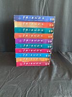 Stacked DVD box sets of Friends TV series, labeled with season numbers from 1 to 10