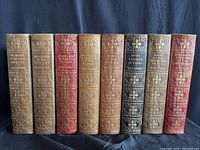 Front view of all eight volumes on black background