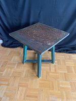 Front view of the solid wood side table showing the square tabletop and blue-green painted legs