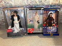 Photo of three Barbie dolls in their original collector edition boxes: Erica Kane, I Love Lucy, and That Girl
