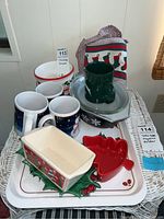 Full view of all items including mugs, bowls, tray, and apron arranged on a wicker table