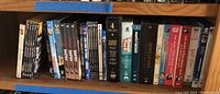 Shelf with DVDs including Hogan's Heroes seasons and other assorted TV show DVDs