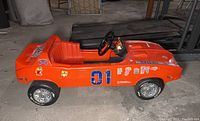 Left side view showing orange body, #01 decal, character stickers, Coleco logo, silver hubcap wheel covers
