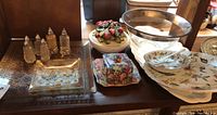 Full view of serving pieces showing plates, bowls, salt and pepper shakers, and covered dish