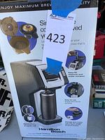 Photo of the Hamilton Beach FlexBrew coffee maker in original packaging showing product and features.