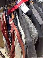 Row of jackets on hangers including souvenir lining and suit jackets