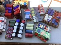 Photo of multiple stacks of poker chips in various colors along with playing cards laid on a tabletop