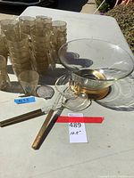 Florentine style glass salad bowl on gold-tone base with matching salad servers and 45 gold-tone plastic punch cups