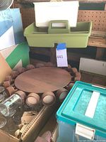 Front view of circular wooden spice rack with jars around edge and additional containers nearby.