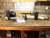 Full view of 37-inch wood turning lathe on workbench, showing motor, bed, tool rest, and tailstock spindle.