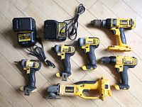 Lot overview with chargers at top left, multiple cordless tools and angle grinder