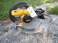 Front-right three-quarter view showing entire saw, blade, base, power cord