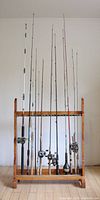 Overall front view of wooden rack holding ten rods