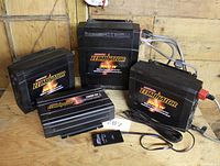 Four inverters arranged on wooden table: 1000W, two 2000W and one 3000W units