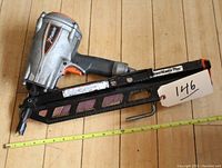 Side view of the PASLODE PowerMaster stick framing nailer showing the magazine, trigger, and brand label.