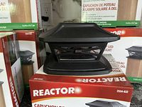 Close up of a single black LED solar post cap showing the design and detailing.