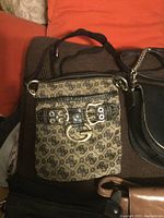 Guess monogram crossbody bag with black trim and buckle detail