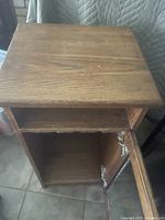 Top surface and open lower cabinet space with door open showing inside storage