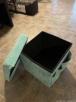 Blue fabric storage cube with removable lid showing inside and one corner damage