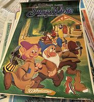 Disney Snow White 50th Anniversary poster featuring the seven dwarfs in a forest scene.