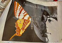 Close-up view of 'Becoming Independent' poster showing colorful butterfly wings overlapping a female face illustration.