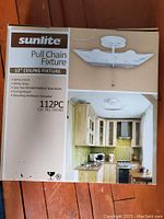 Photo of original box showing Sunlite branding, product name, and kitchen installation example.