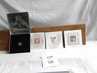 Full set showing silver medallion in open presentation case and three commemorative stamp cards.