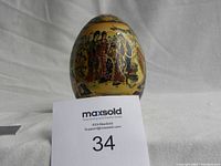 Front view of the decorative Satsuma-style egg figurine with traditional Japanese figures and floral patterns