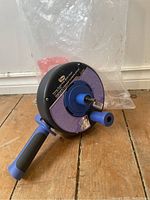 Side view of Cobra Power Pistol Grip Drum Auger with handle and cable spool visible