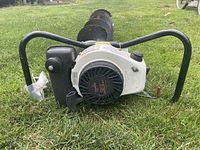 Front close-up of the white gas engine housing and black pull start wheel labeled 3.5hp, with black handles on each side.