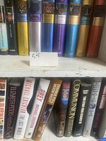 Close up of hardcover books from the Warriors Super Edition series and other fiction titles