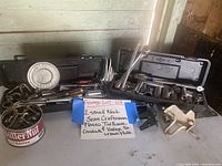 Overall view of two black Sears Craftsman plastic tool boxes opened showing socket sets, plus vintage Butternut Coffee metal can with assorted hardware pieces and small miscellaneous tools.