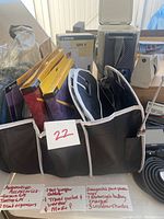 Overview of automotive accessories showing GPS devices, trunk organizers, jumper cables, magnetic cups, charger and sunshades.