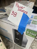 APC backup power supply in original box showing product details and savings.