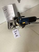 Mastercraft biscuit joiner tool with owner's manual placed on table, showing overall tool and manual.