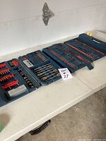 Full view of the open drill bit case showing the organization of bits and some gaps where bits are missing.