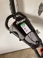 Close-up of the handle and control panel of the golf push cart showing brand and buttons.