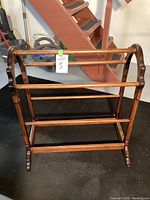 Front view of the wooden quilt rack showing overall structure and design.