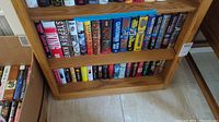Wide view of two shelves with various hardcover books by Stephen King, Richard Bachman, and others showing titles and colorful dust jackets.