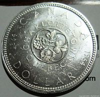 Reverse side of the 1964 Canadian silver dollar coin showing the floral emblem and inscriptions.