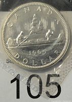 Obverse side of the 1965 Canada silver prooflike dollar coin showing the canoe with two paddlers and the year 1965.